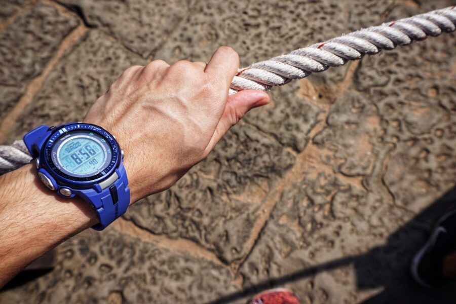 Person adjusting sports watch strap