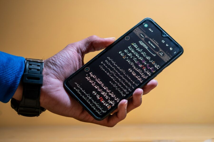 Hand holding smartphone privacy settings screen