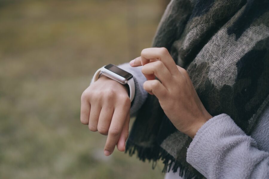 Person checking activity band arm outdoors