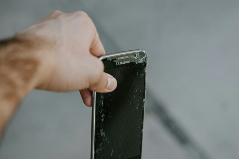 Person inspecting used smartphone screen
