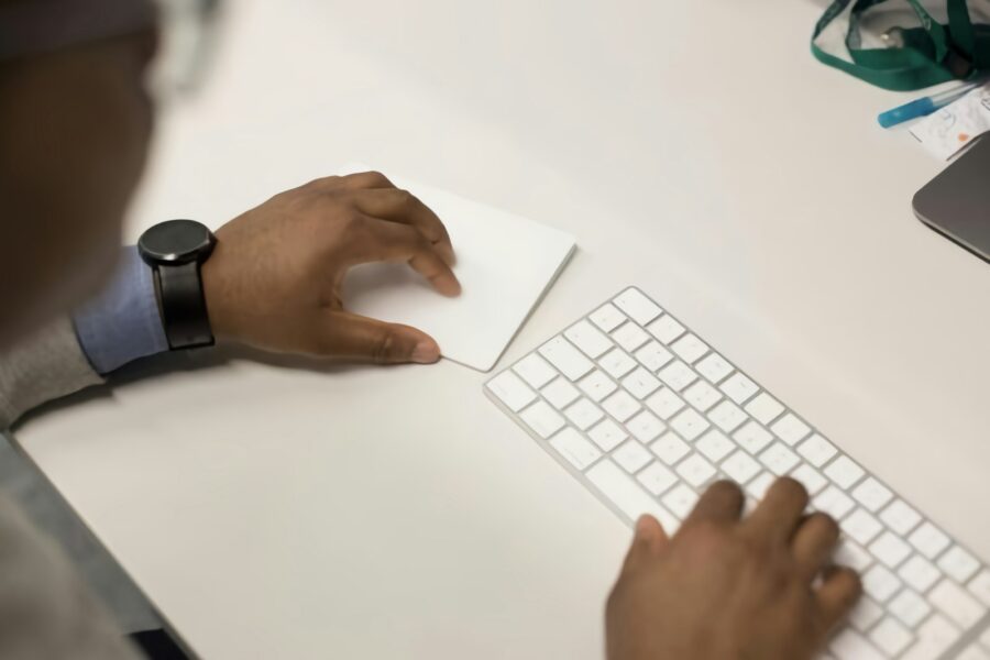 Person cleaning notebook keyboard microfiber cloth