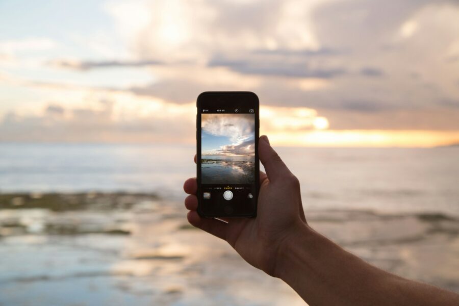 Person using smartphone camera outdoors
