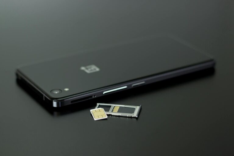 Person checking smartphone storage microsd card smartphone table
