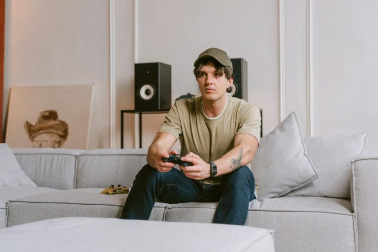 Gamer wearing headset controller couch gaming headset microphone