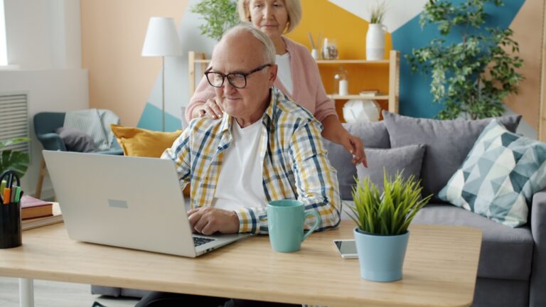 Family using laptop living room table