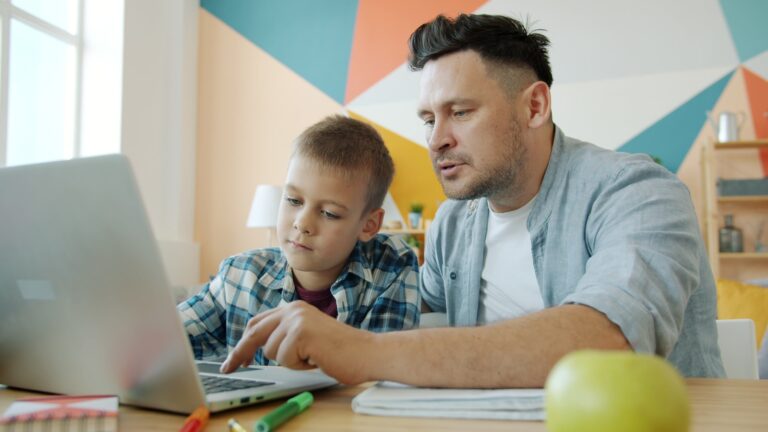 Child doing homework shared family laptop
