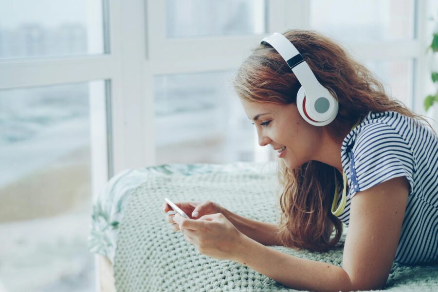 Person listening streaming music wireless headphones home