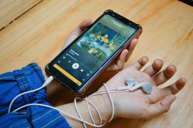 Hand adjusting audio settings smartphone music app