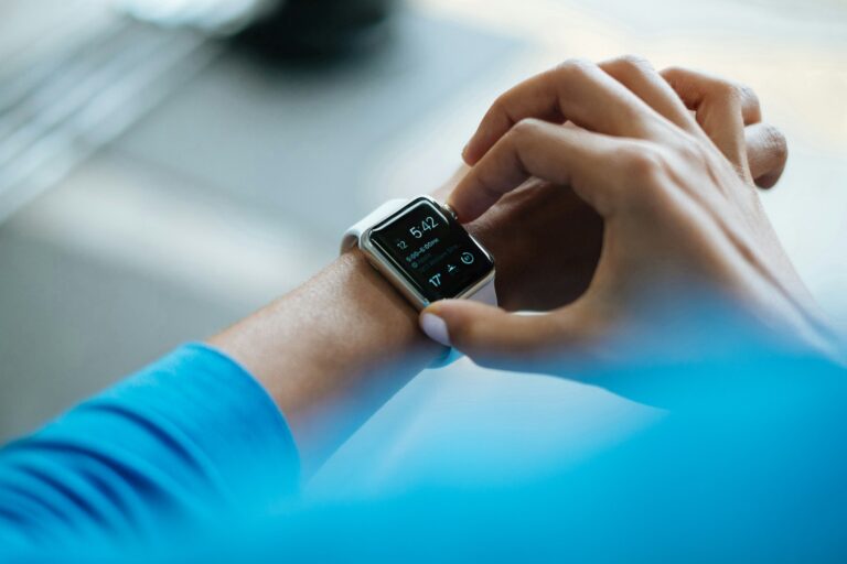 Person taking call smartwatch kitchen