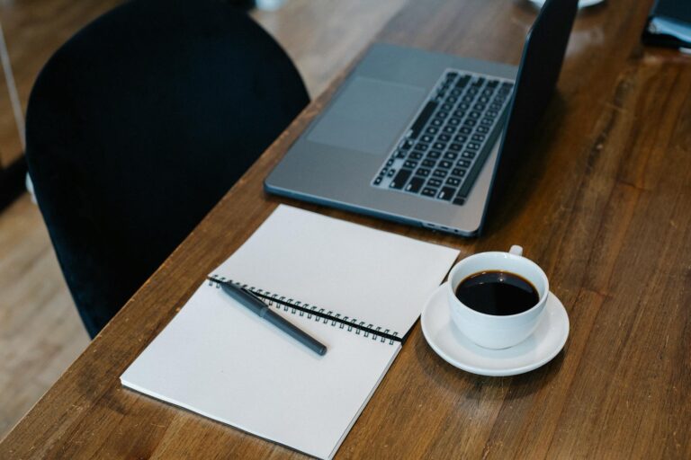 Thin laptop wooden desk coffee cup notebook