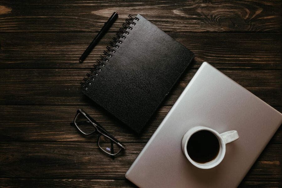 Thin laptop wooden desk coffee cup notebook