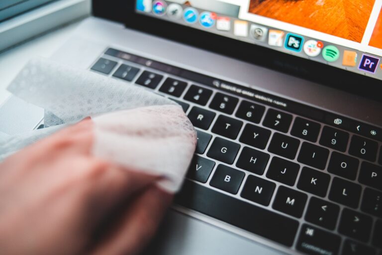 Person cleaning laptop